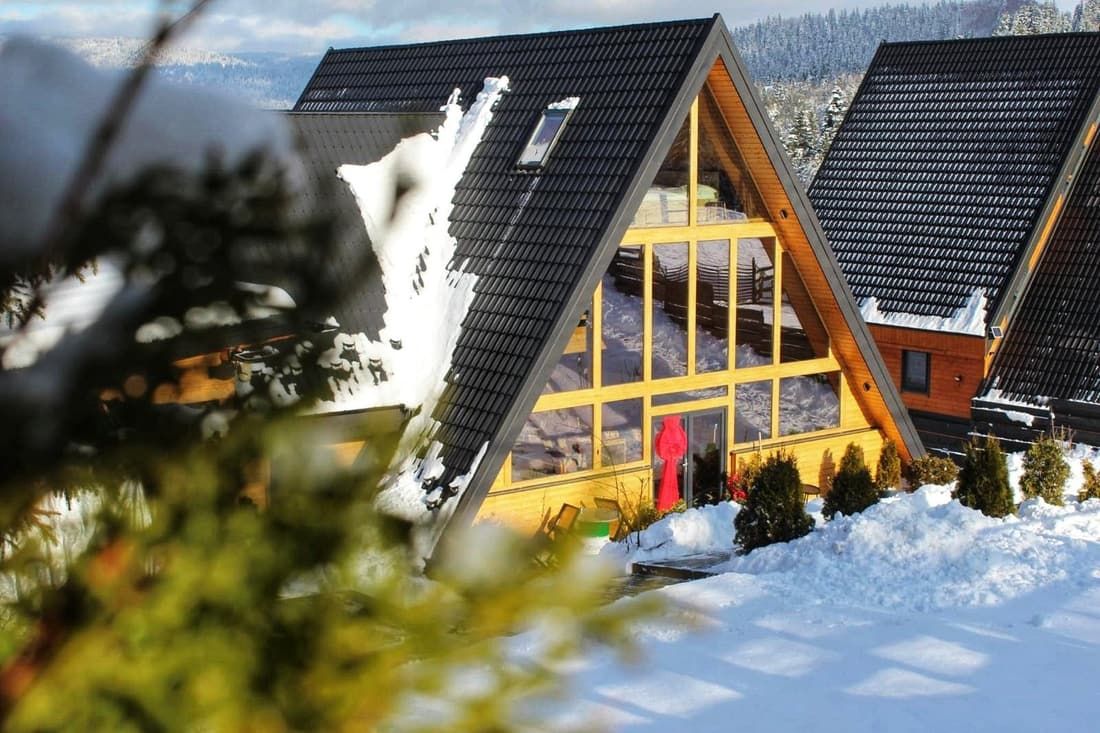 The A-Frame cabin in winter, snow on the roof